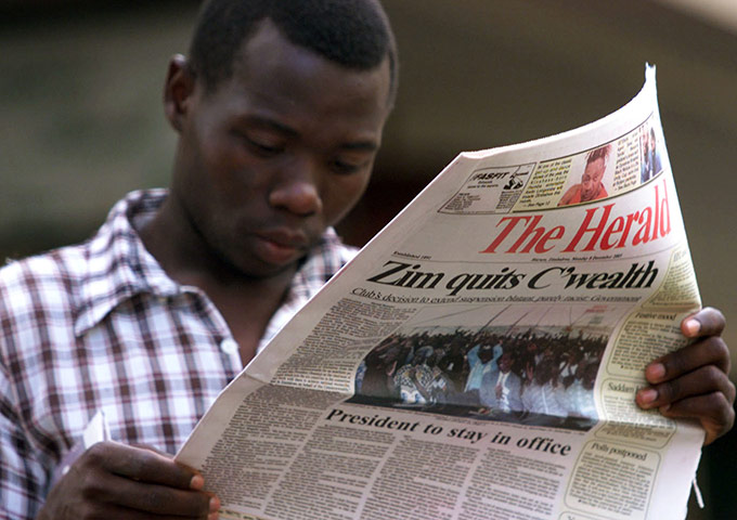 Robert Mugabe: December 2003: A Zimbabwean reads a copy of the state-owned newspaper