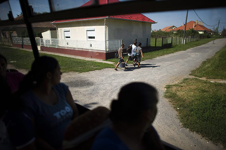 FTA: Attila Balazs: Day-workers look out of their bus as they arrive back home in Tiszavasvari