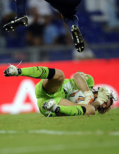 Europa League: Lazio goalkeeper Federico Marchetti dives at the feet of a Vaslui player