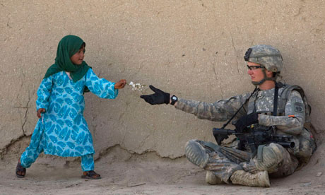 US soldier receives flowers from an Afghan girl