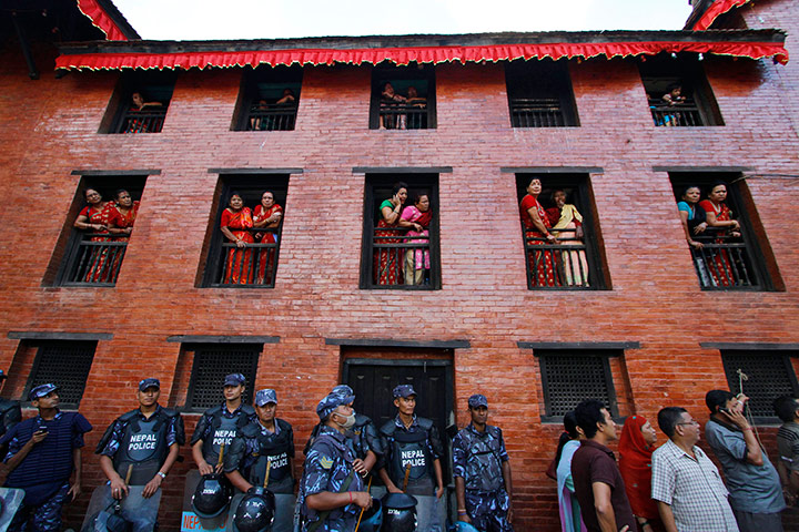 24 hours in pictures: Nepalese women watch a chariot procession at Indra Jatra festival