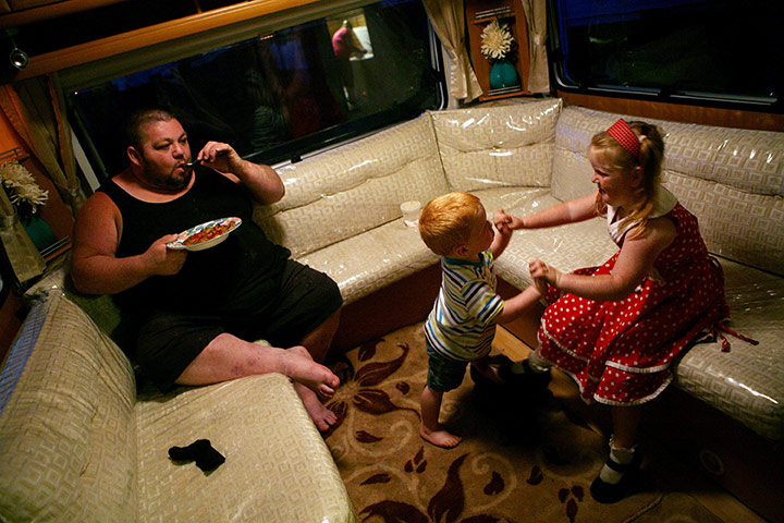 Dale Farm: Dennis and Viviana Sheridan playing, while Dennis's father John eats