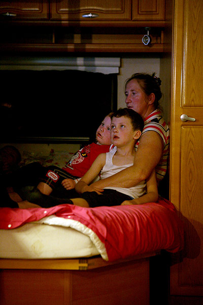 Dale Farm: Barbara with Dennis and John, watching TV, September 2011