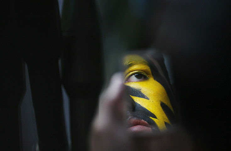 24 Hours: The painted face of a special forces soldier is reflected in a mirror
