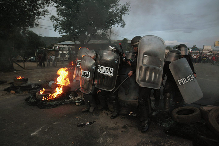 24 Hours: Riot police officers near a bonfire in the village of El Tejar