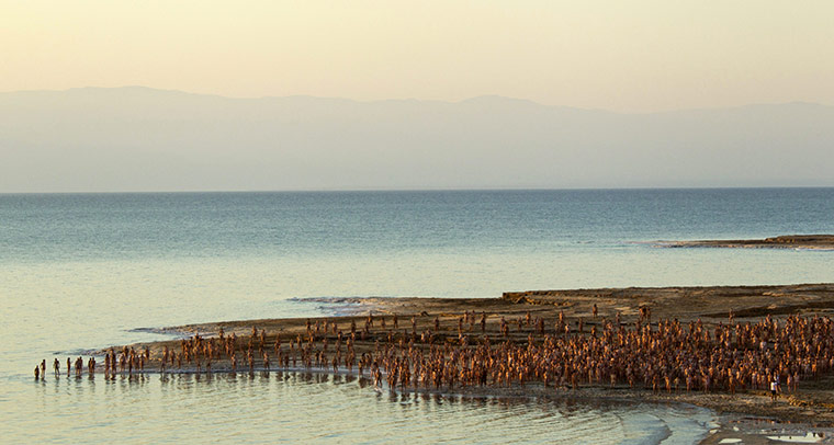 24 Hours: Models for artist Spencer Tunick at the water's edge at the Dead Sea