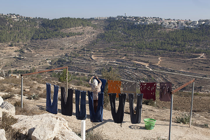 Levene West Bank: A woman hangs out clothes to dry at Al Walaja in the West Bank