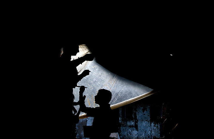 24 hours: New Delhi, India: An Indian artisan works on semi-finished clay idols