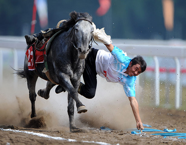 24 hours: Guiyang, China: A player picks up hada at the 9th Chinese Traditional Games