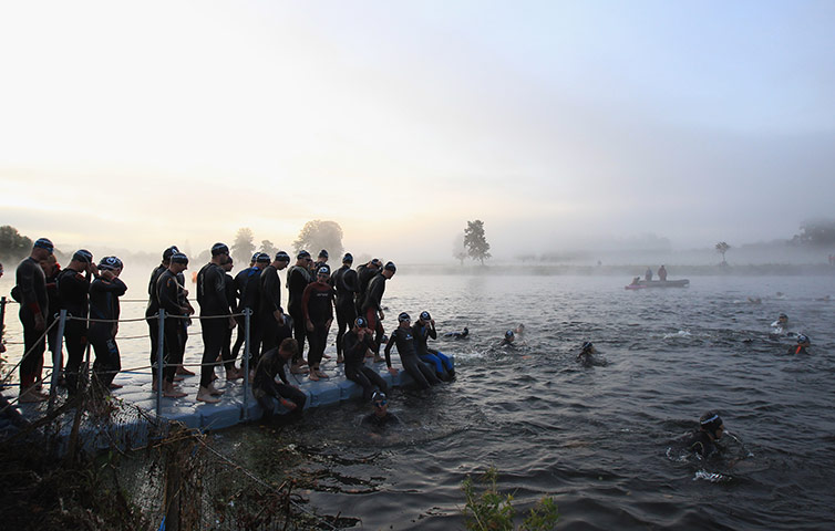 24 hours: Henley-on-thames, England: Athletes in the swimming leg of a triathlon