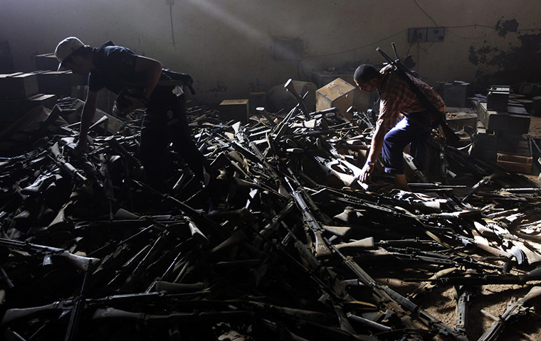 24 hours: Libya: Anti-Gaddafi fighters salvage weapons from a pro-Gaddafi compound