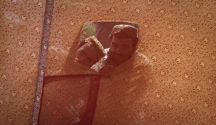 24 hours: Karachi, Pakistan: Men through past a cloth barrier at suicide bomb attack 