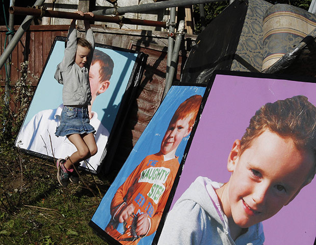 Dale Farm: a girl swings on scaffolding
