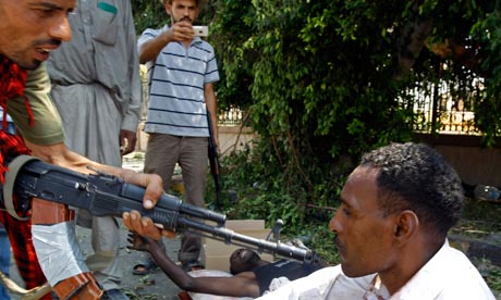 Man pointing rifle at alleged mercenary