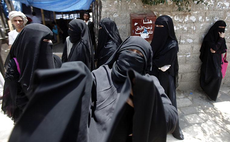 Yemen violence: A woman reacts as she waits outside a makeshift clinic 
