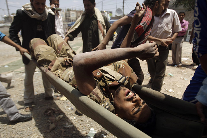 Yemen violence: Anti-government protesters carry wounded defected soldier