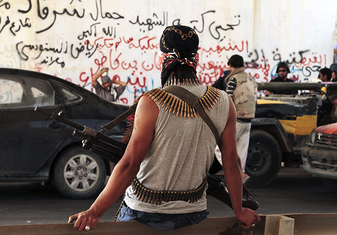 Libya fighting continues: Revolutionary fighters gather at a strategic checkpoint outside Sirte