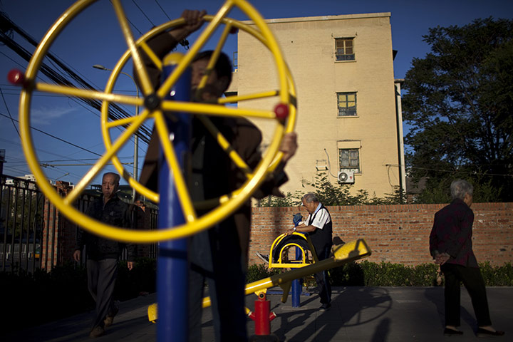 24 hours in pictures: Elderly people perform early morning exercises in a Beijing park