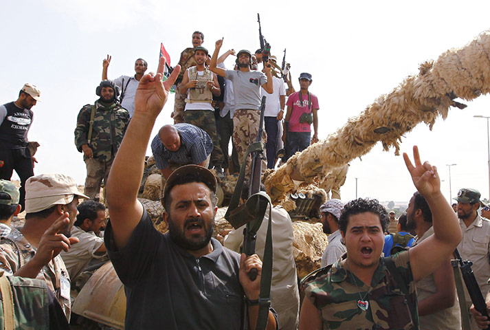 Libya fighting continues: NTC fighters celebrate on a tank they said they captured 