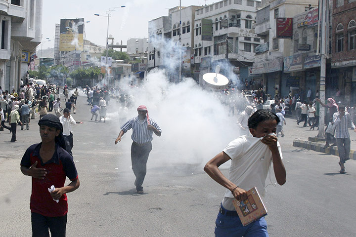Yemen violence: Anti-government protesters are tear gassed during clashes in Taiz