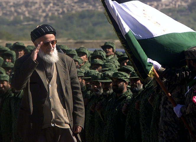 President Rabbani: 2001: President Burnahuddin Rabbani salutes the Afghan flag