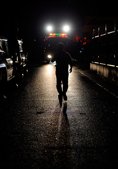 Typhoon Roke: A man walks towards a fire brigade truck near a river bank in Nagoya