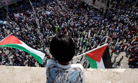 A Palestinian boy at a rally in support of an independent Palestine (Photo courtesy of The Guardian).