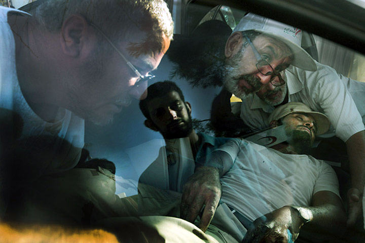 24 hours in pictures: A casualtiy is brought in from the front line to a hospital in Misrata