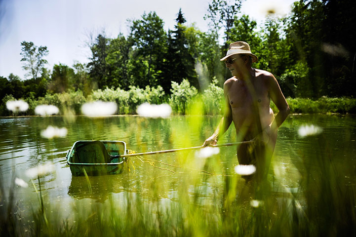 FTA: Mark Blinch: A man carries out maintenance in the pond
