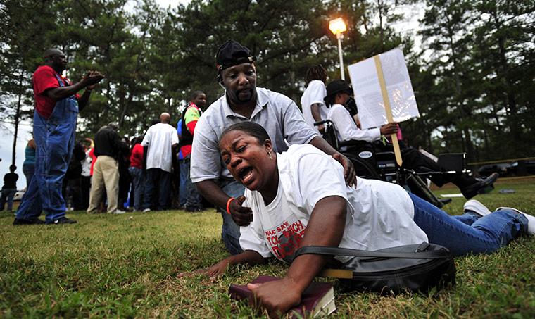 troy davis execution: A protester is helped off the ground 