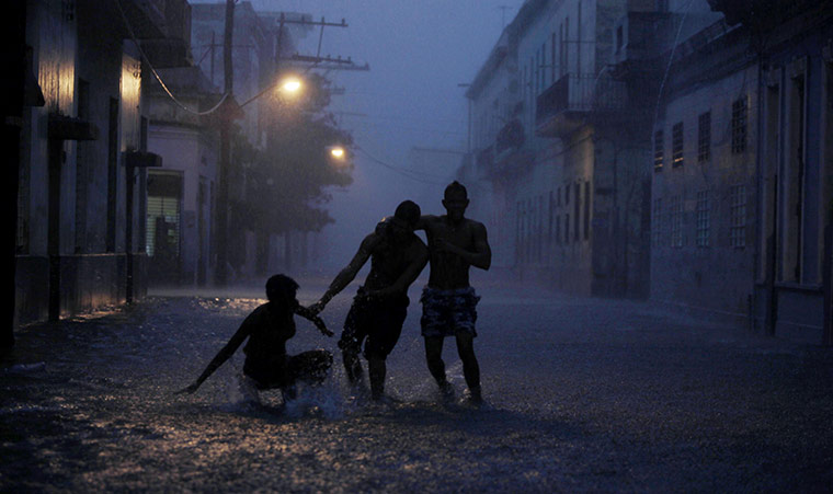 24 hours in pictures: Locals make their way along a flooded street in Havana, Cuba