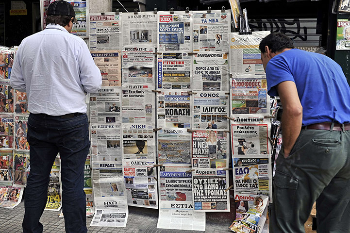 Strike in Greece: People read newspaper headlines