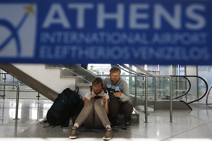 Strike in Greece: Passengers sit inside a hall at Athens' Eleftherios Venizelos airport