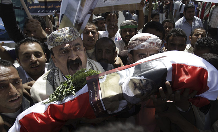 Yemen violence resumes: Relatives and protesters carry the body of a child killed in cross fire 