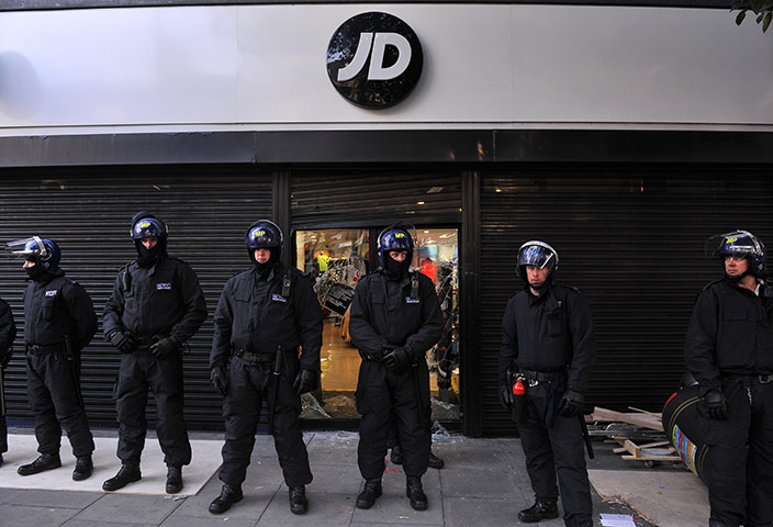 Week in Business: Riot police guard a looted JD sports store  in  August
