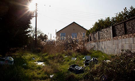 House with rubbish outside