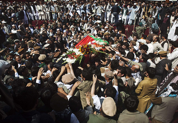 Rabbani funeral: Mourners carry the coffin through a crowd