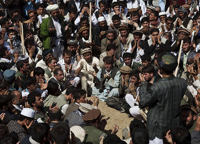 Rabbani funeral: Mourners pray over the grave