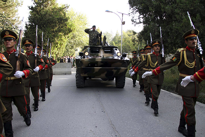 Rabbani funeral: Soldiers march with a military vehicle transporting the coffin