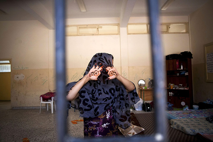 24 hours in pictures: Misrata, Libya: A woman suspected of being a Gadhafi loyalist