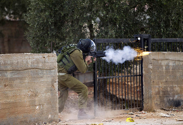 West Bank clashes: An Israeli soldier fires tear gas