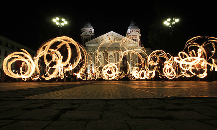 24 Hours: Fire spinners whirling fire in front of the National Theatre