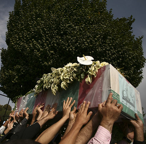 24 Hours: Iranians carry a flag draped coffin of an unknown soldier