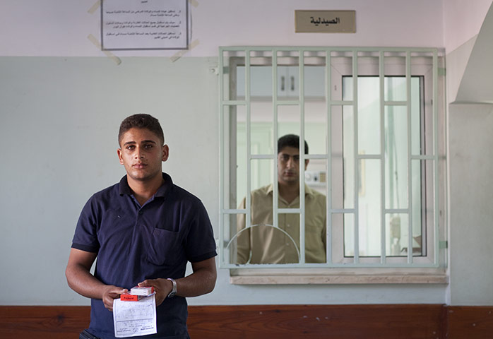 Palestinian Lives: Palestinian Ali Al Atar, 17, is picks up medicine for his mother