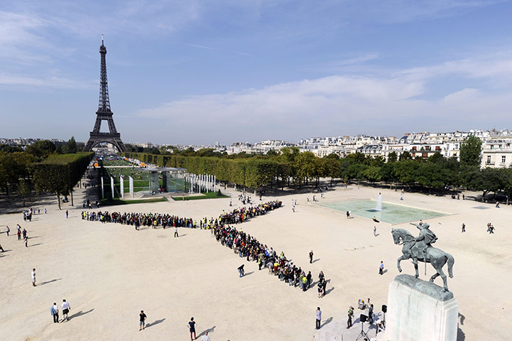 24 hours in pictures: Paris, France: Greenpeace activists gather to create a wind turbine