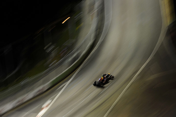 24 hours in pictures: Singapore: Mark Webber drives during a practice session for F1 Grand Prix