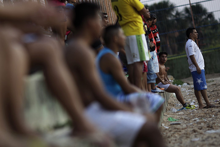 24 hours in pictures: Manaus, Brazil: A player in underwear after lending his kit to a teammate