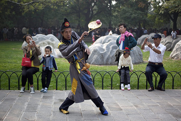 24 hours in pictures: Beijing, China: A Rouli-ball enthusiast dressed as a folk hero beggar monk 