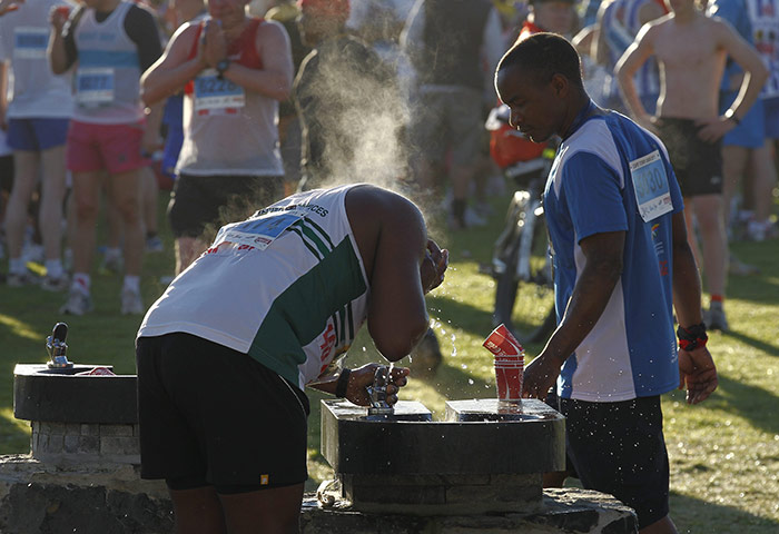 24 hours in pictures: Cape Town, South Africa: Runners cool off after the marathon