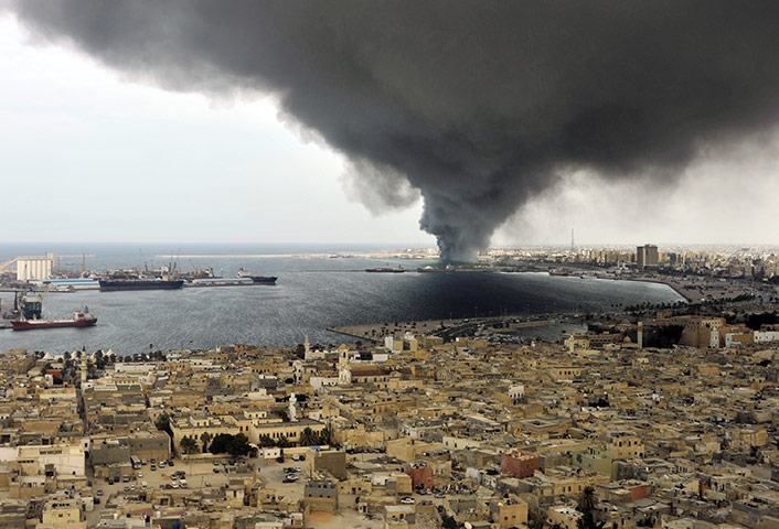 24 hours in pictures: Tripoli, Libya: A huge plume of smoke rises over the harbour